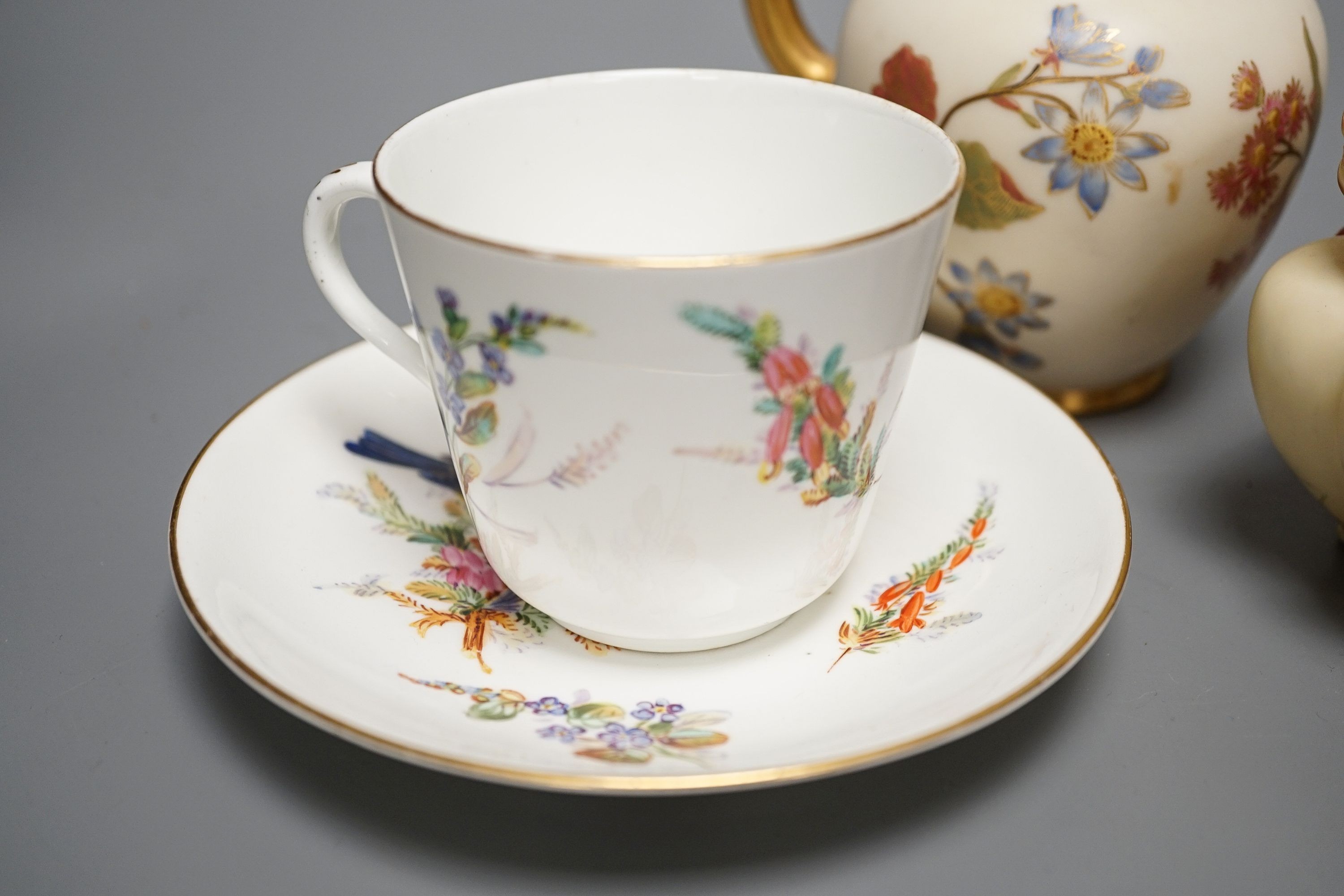 A Worcester bird painted cup and saucer, a blush ivory jug and pot and an ivory jug